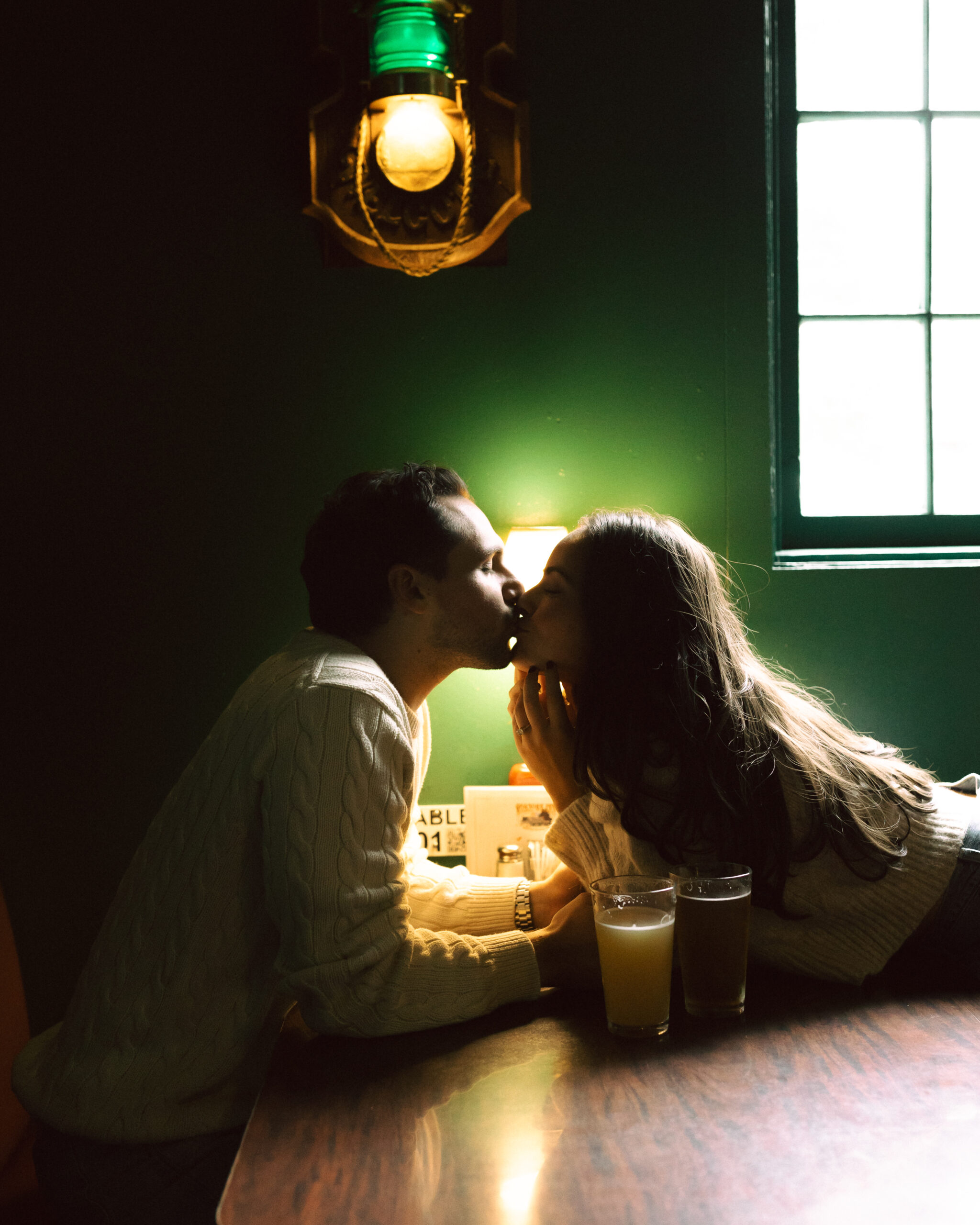 Couple kissing at a dive bar in Seattle Washington